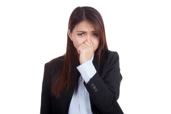 Giovane donna d'affari asiatica tenendo il naso a causa di un cattivo odore Fotografia Stock