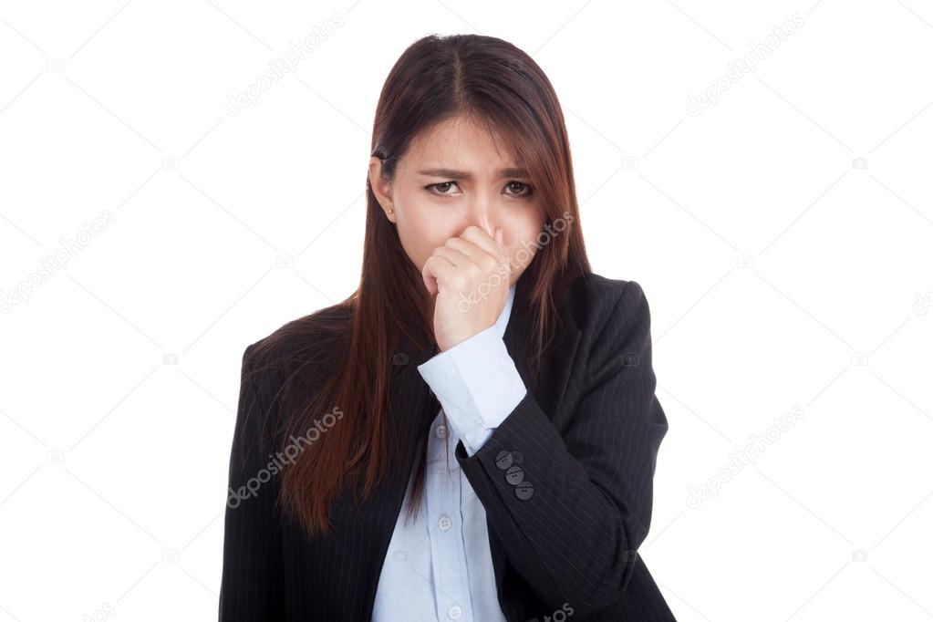 Young Asian businesswoman holding her nose because of a bad smel