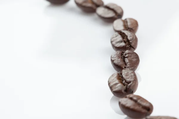 Dotted line of coffee beans — Stock Photo, Image