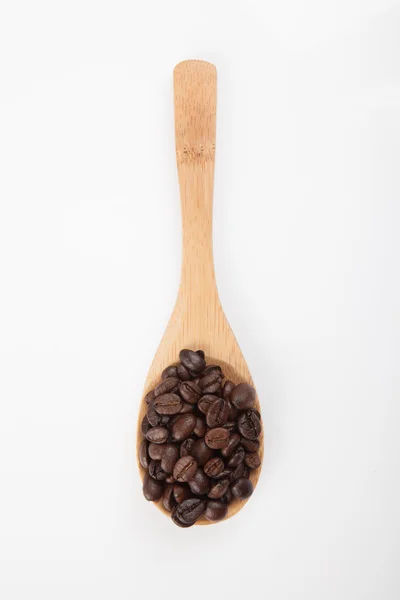 Roasted coffee beans with wooden spoon — Stock Photo, Image