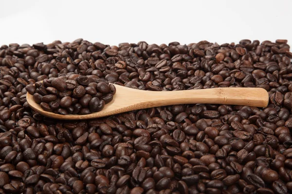 Roasted coffee beans with wooden spoon — Stock Photo, Image