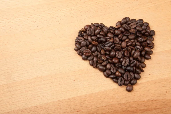 Roasted coffee beans in heart shape — Stock Photo, Image