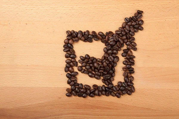 Roasted coffee beans in check mark in box shape — Stock Photo, Image