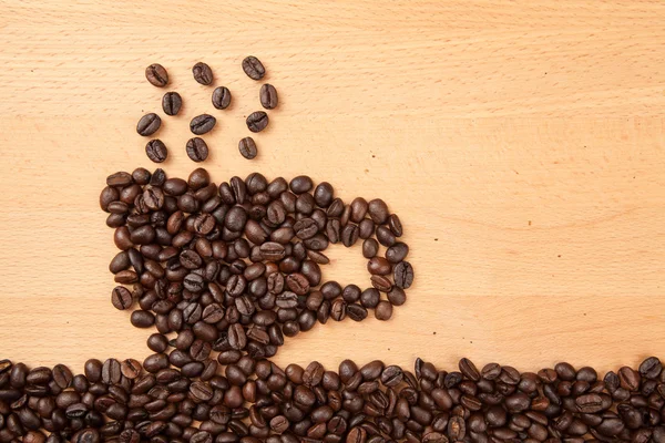 Gebrande koffiebonen in koffie beker vorm — Stockfoto