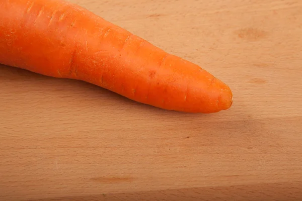 Carrot on wooden background — Stock Photo, Image