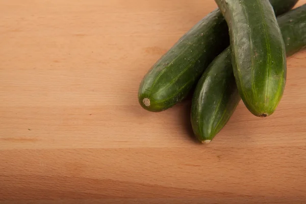 Cucumbers on wooden table — Stock Photo, Image