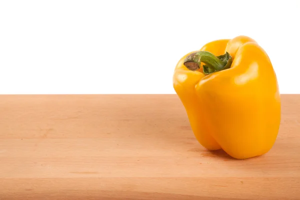 Yellow bell pepper on wooden table — Stock Photo, Image