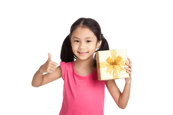 Kleine asiatische Mädchen mit Geschenk-Box zeigen Daumen nach oben — Stockfoto