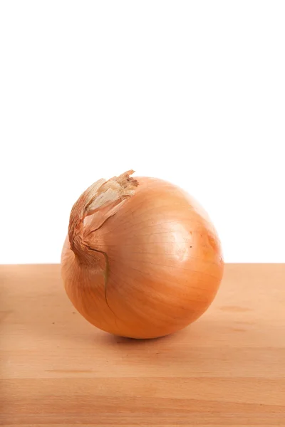 Onions on wooden table — Stock Photo, Image