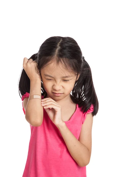 Little asian girl  hurt with bandage on her arm — Stockfoto