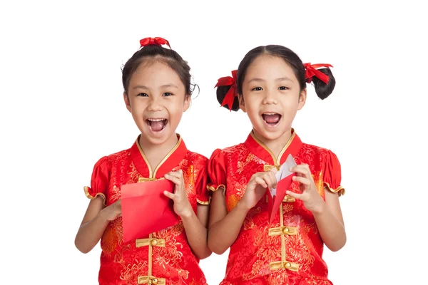 Asiático gêmeos meninas em chinês cheongsam vestido com envelope vermelho — Fotografia de Stock