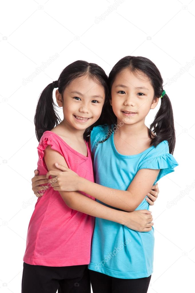 Asian twins girls  smile hug each other