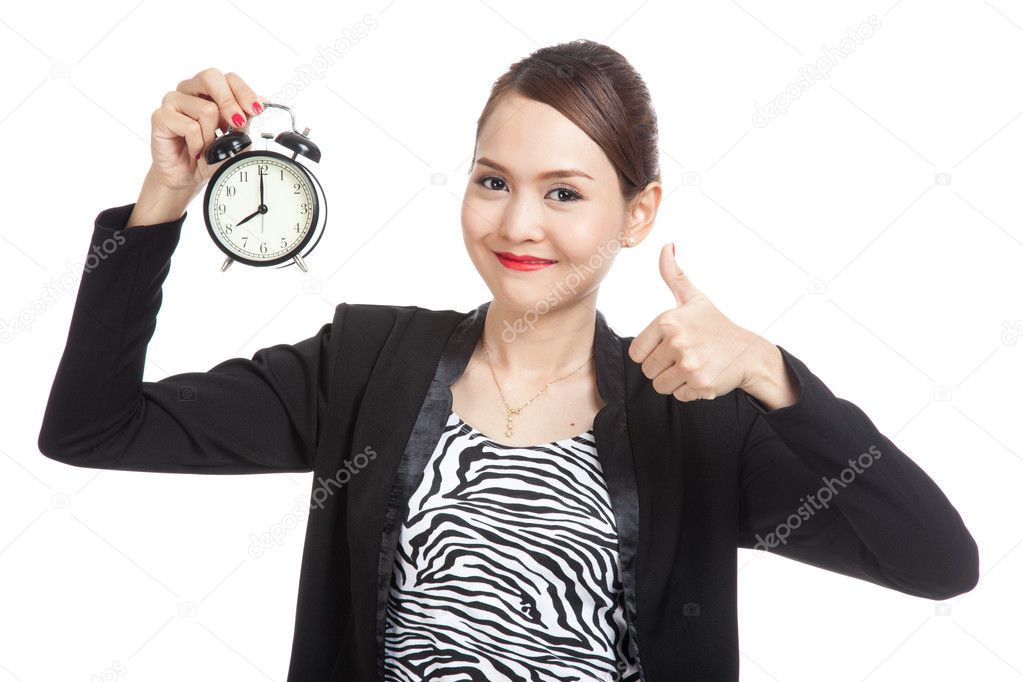 Young Asian business woman show thumbs up with a clock