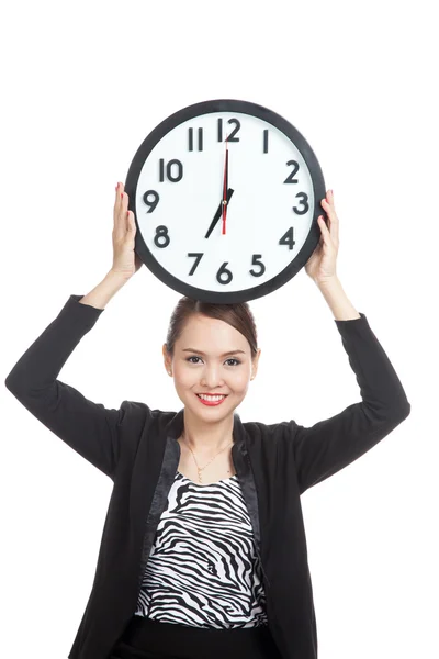 Young Asian business woman with a clock Royalty Free Stock Images