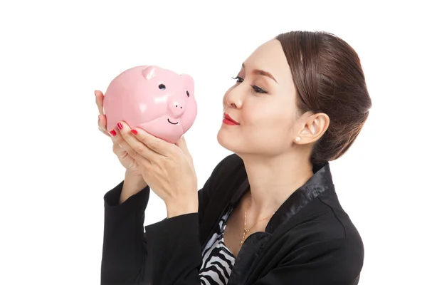 Young Asian business woman kiss  a pink coin bank — Stock Photo, Image