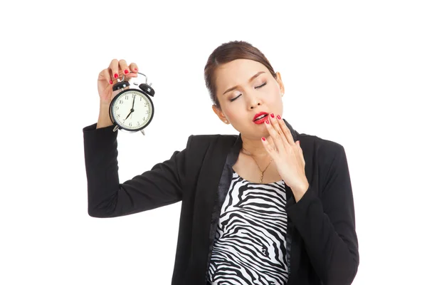 Somnolent jeune femme d'affaires asiatique avec une horloge le matin Images De Stock Libres De Droits