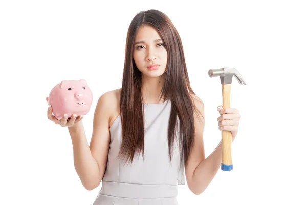 Unhappy  young Asian woman with piggy bank and hammer — Stock Photo, Image