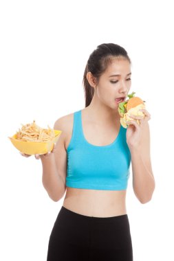 Güzel Asyalı sağlıklı kız hamburger ve patates kızartması ile