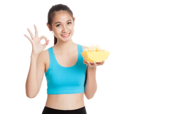 Beautiful Asian healthy girl  eat potato chips show OK sign — Stock Photo, Image