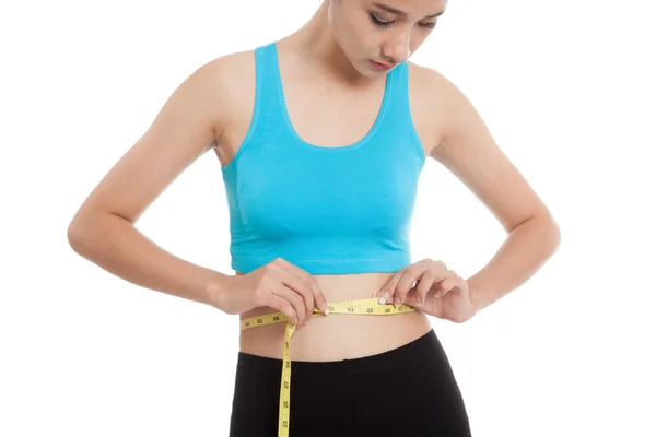 Beautiful Asian healthy girl measuring her waist — Stock Photo, Image
