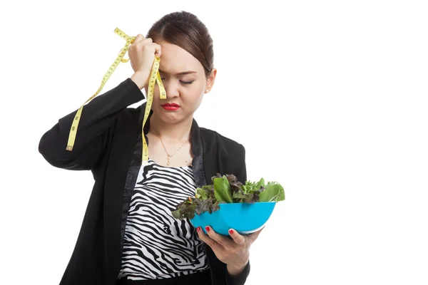 Unhappy Asian business woman with measuring tape and salad — Stock Photo, Image