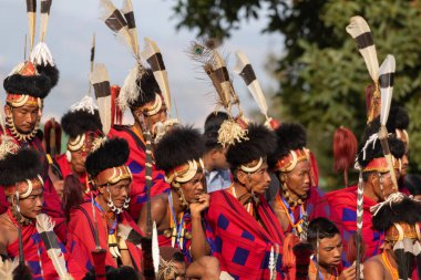 4 Aralık 2016 'da Hindistan' ın Nagaland kentindeki Kisama Köyü arenasında geleneksel kıyafetlerini giymiş ve birlikte oturan Naga kabilesinin seçici odak noktası.