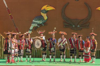 A group of Naga tribe people playing their folk music and performing traditional folk dance on stage during Hornbill festival at Nagaland India on 4 December 202016