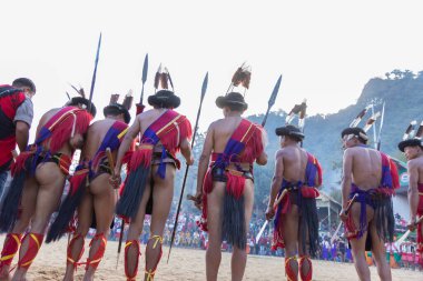 Selective focus image of Tribal men of Nagaland standing with their spears at Kisama village in Nagaland India on 2 December 2016