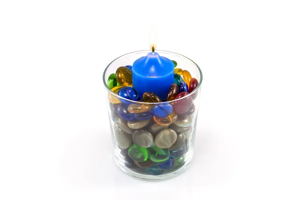 Glass of gems and a candle — Stock Photo, Image