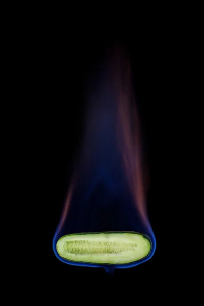 Cucumber on fire — Stock Photo, Image