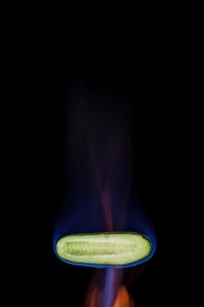 Cucumber on fire — Stock Photo, Image