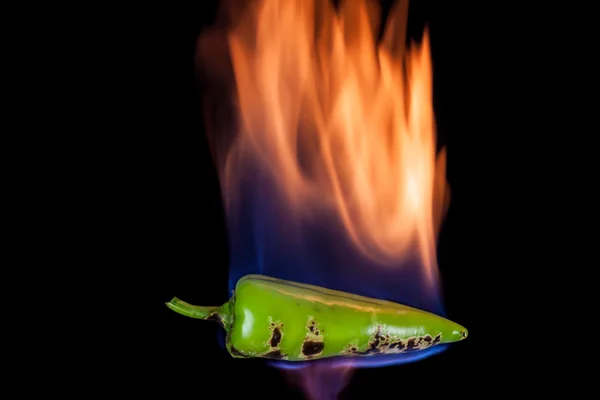 Green pepper on fire — Stock Fotó