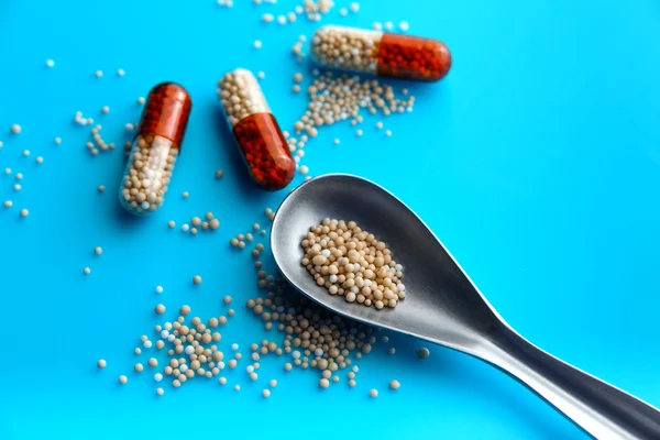 renkli hapları ve arka planda tabletleri