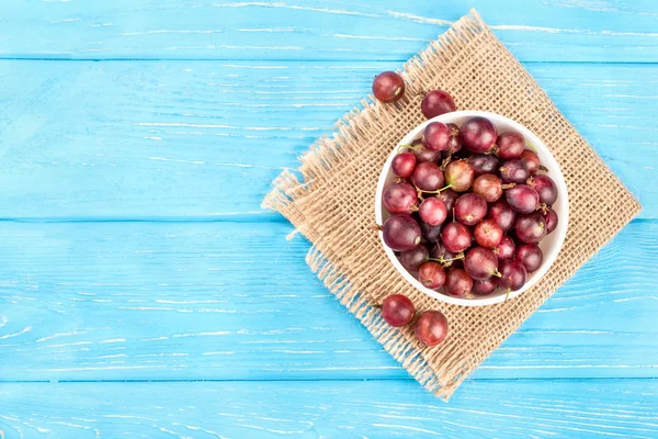 Red gooseberries in bowl — Stock Photo, Image