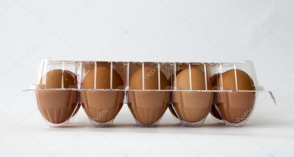 Ten brown chicken eggs in plastic container package