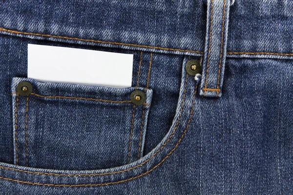 Part of white card paper in the front pocket of blue denim jeans — Stock Photo, Image