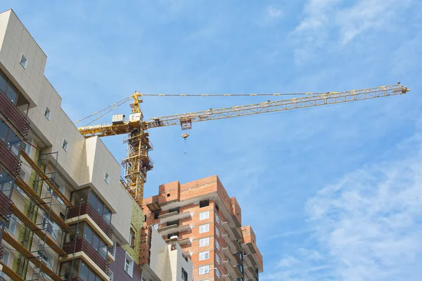 Construction crane between buildings — Stock Photo, Image