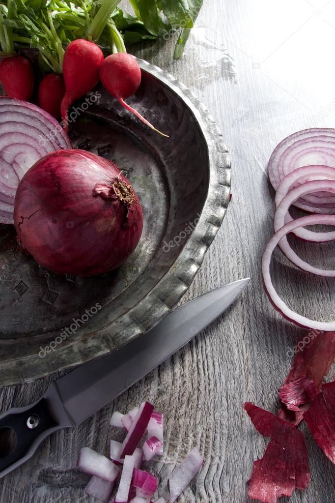 Red onion with radish on old vintage plate