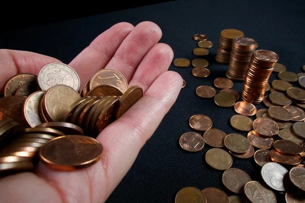 Business and money saving concept - close up of female hand with euro cents and column of money — Stock Photo, Image