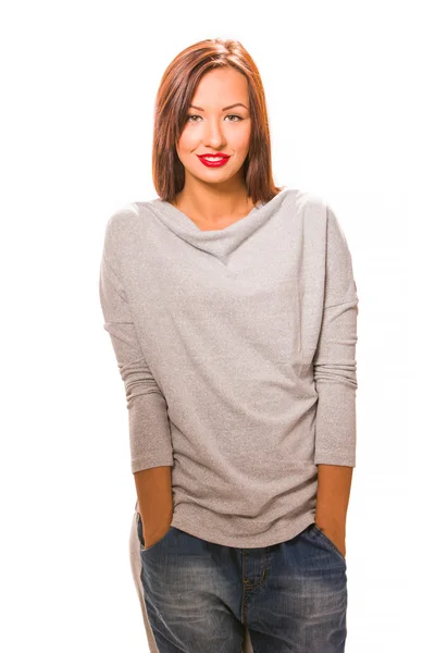 Beautiful happy young woman standing with hands in pockets. — Stock Photo, Image