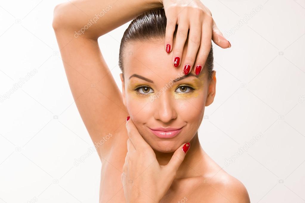 Brown sleek hair beautiful woman with hands close to face.