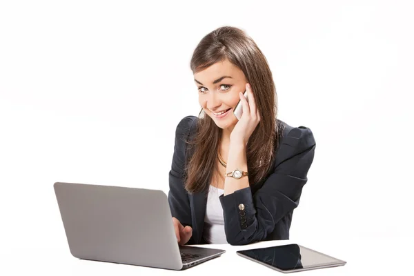 Young business woman working on laptop. Royalty Free Stock Photos