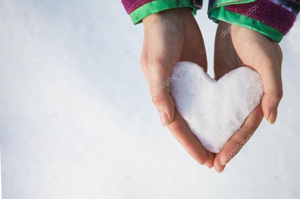 Ice heart in female hands
