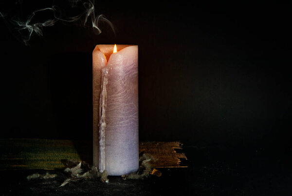 White candle on a dark background