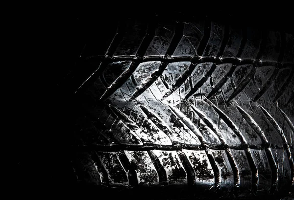 A tire made of metal on black background