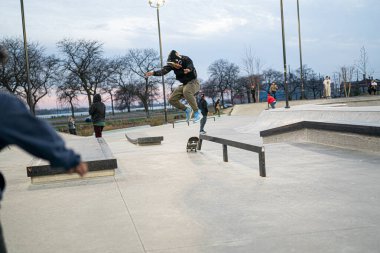 Patenciler ve motorcular 19 Kasım 2020 'de Detroit, Michigan / ABD' de bir açık hava kaykay parkında numara yapıyorlar.