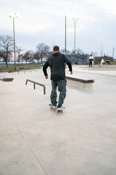 stock image skaters and bikers practice tricks at an outdoor skate park in Detroit, Michigan / USA - November 19 -2020