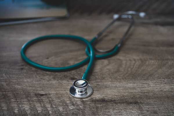 stethoscope in shallow depth of field is laying on the desk