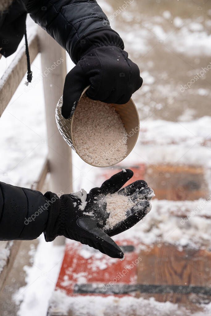 rock salt ice melt is being spread on your walkway to melt the ice and snow from your path