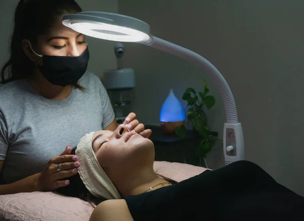 Young woman receiving natural eyelash lift treatment